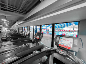 Fitness classes like Tread n' Shed are held in the fitness center overlooking the Olympic-size pool.
