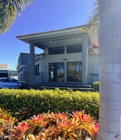 The front entrance of the Rosen Aquatic and Fitness Center with landscaping out front and blue sky in the background. The start of our photo tour.