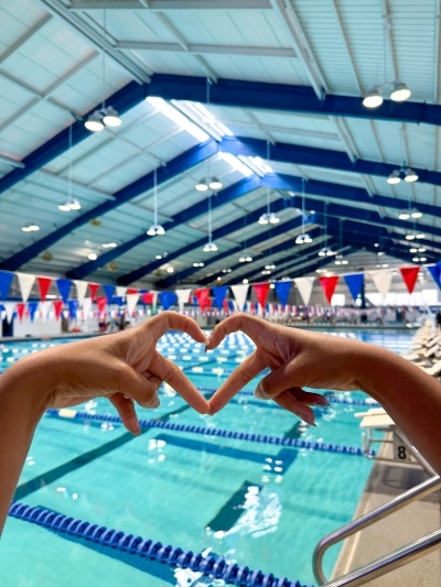Two hands forming a heart to celebrate Breast Cancer Awareness Month at Rosen Aquatic & Fitness Center in Orlando.