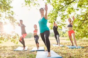 A group of young people practicing tai chi outside